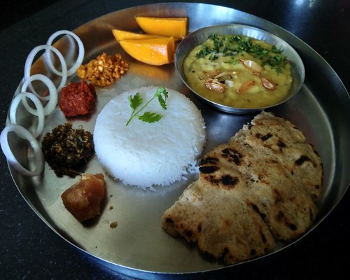 A traditional Indian Thali with Dal, Roti, and Vegetables