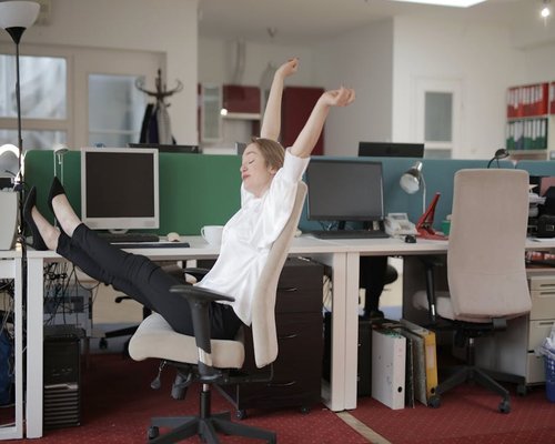Person stretching at office desk